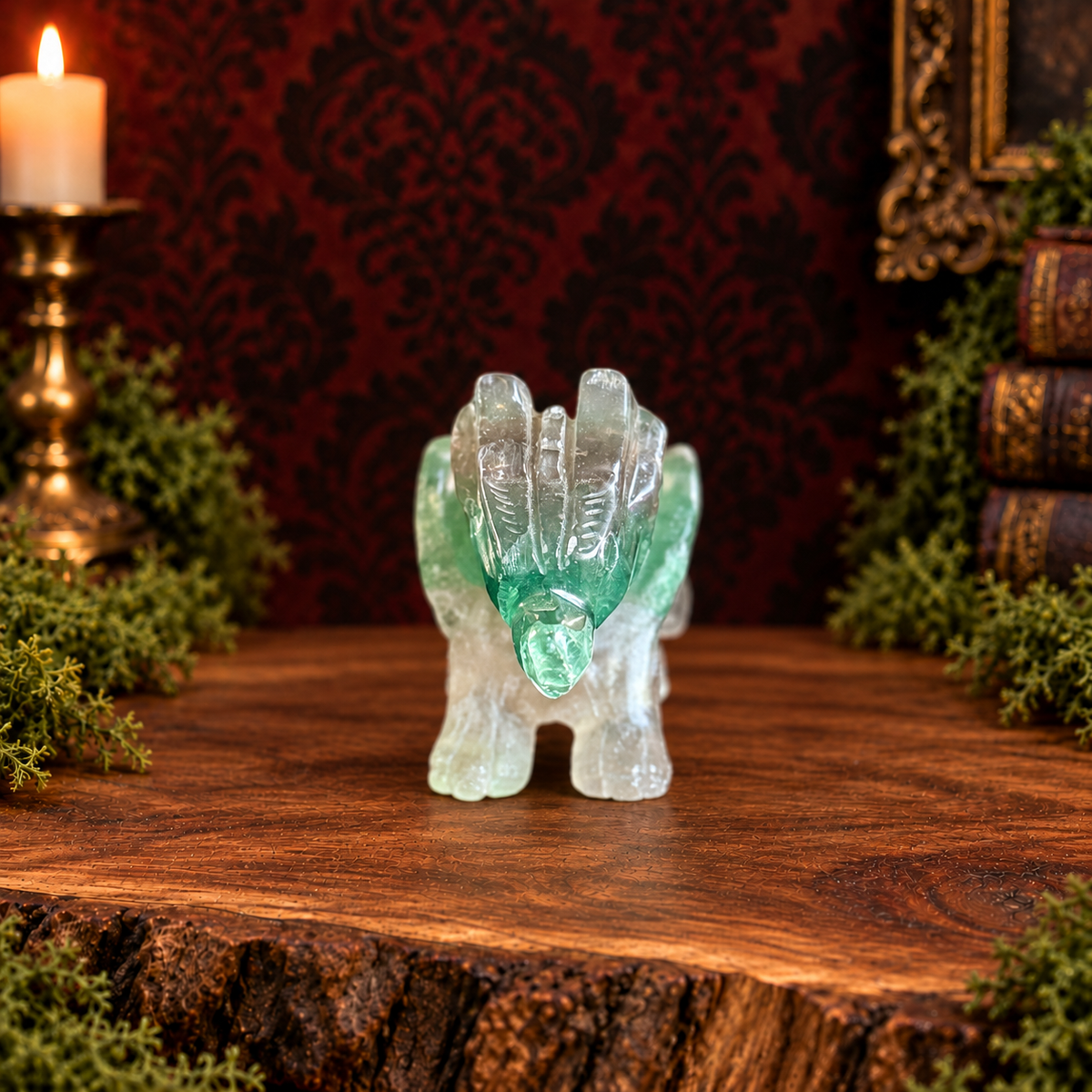 Green fluorite flying dragon, front view on acacia wood with moss and a dark Victorian background.