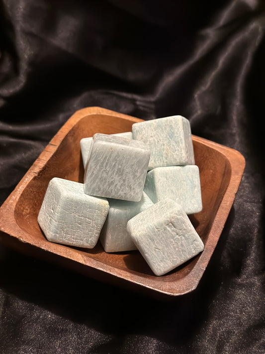 Amazonite crystal cube, held in hand for scale