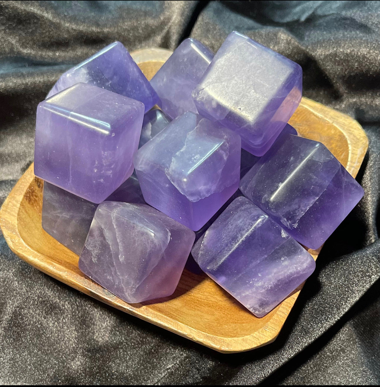 Indigo Fluorite crystal cube, held in hand for scale