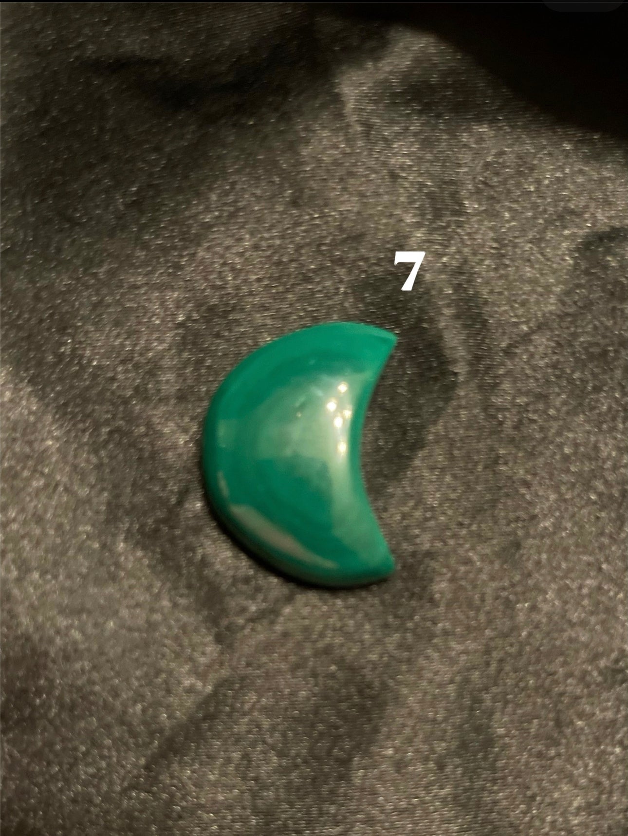 Malachite Moon carved crystal, turned to catch the light
