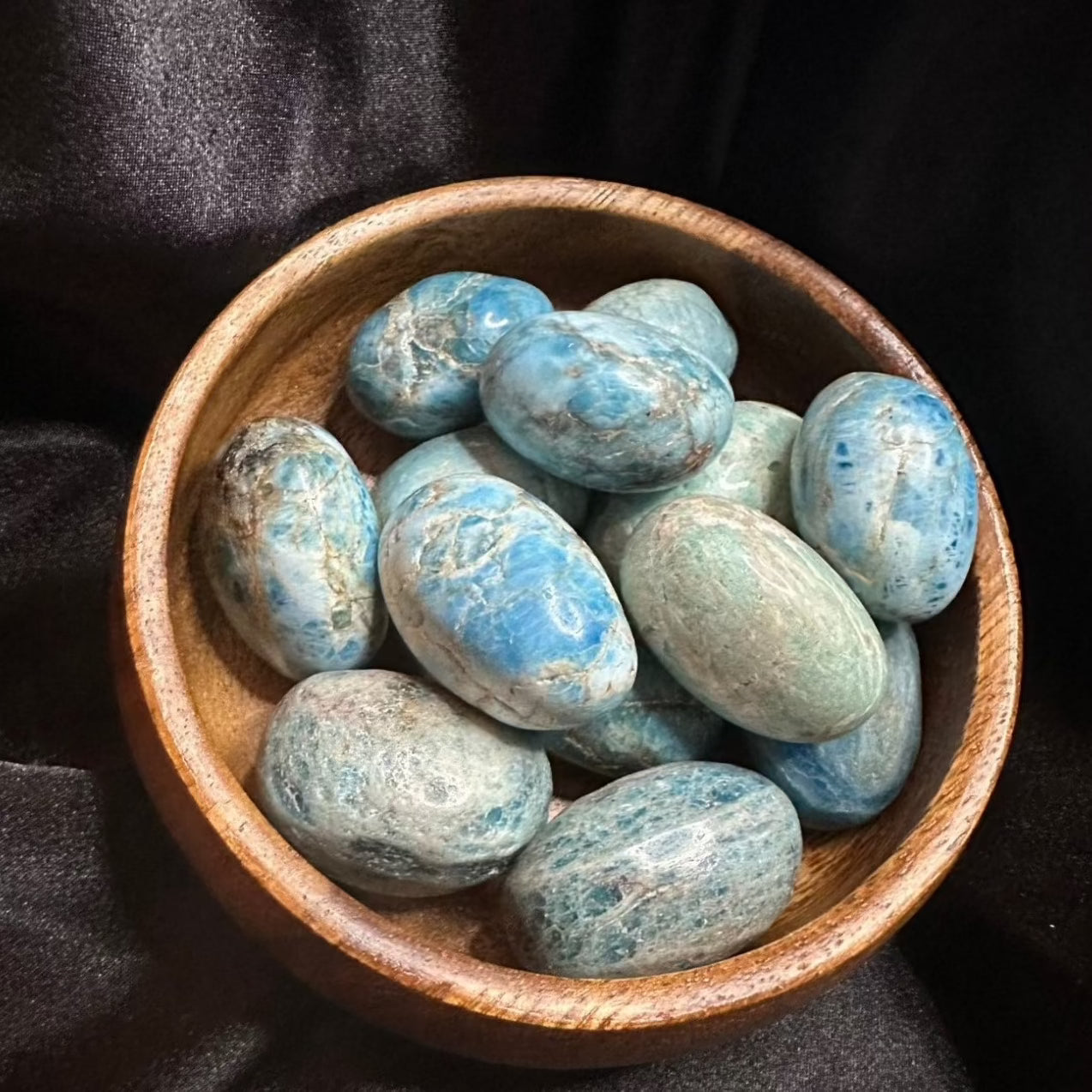 Apatite tumbled stone, deep teal-blue, translucent