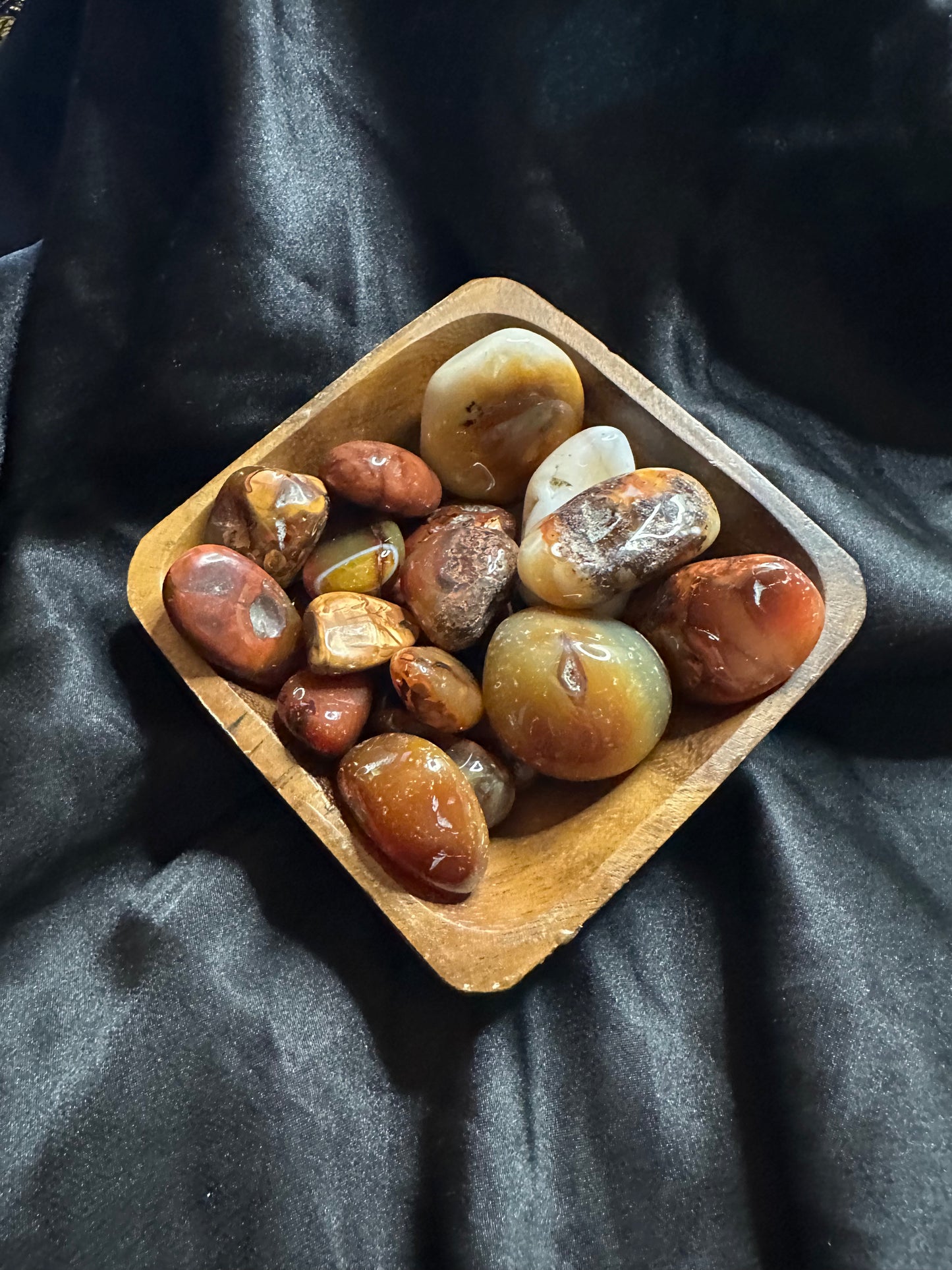 Carnelian tumbled stone, warm translucent orange-red
