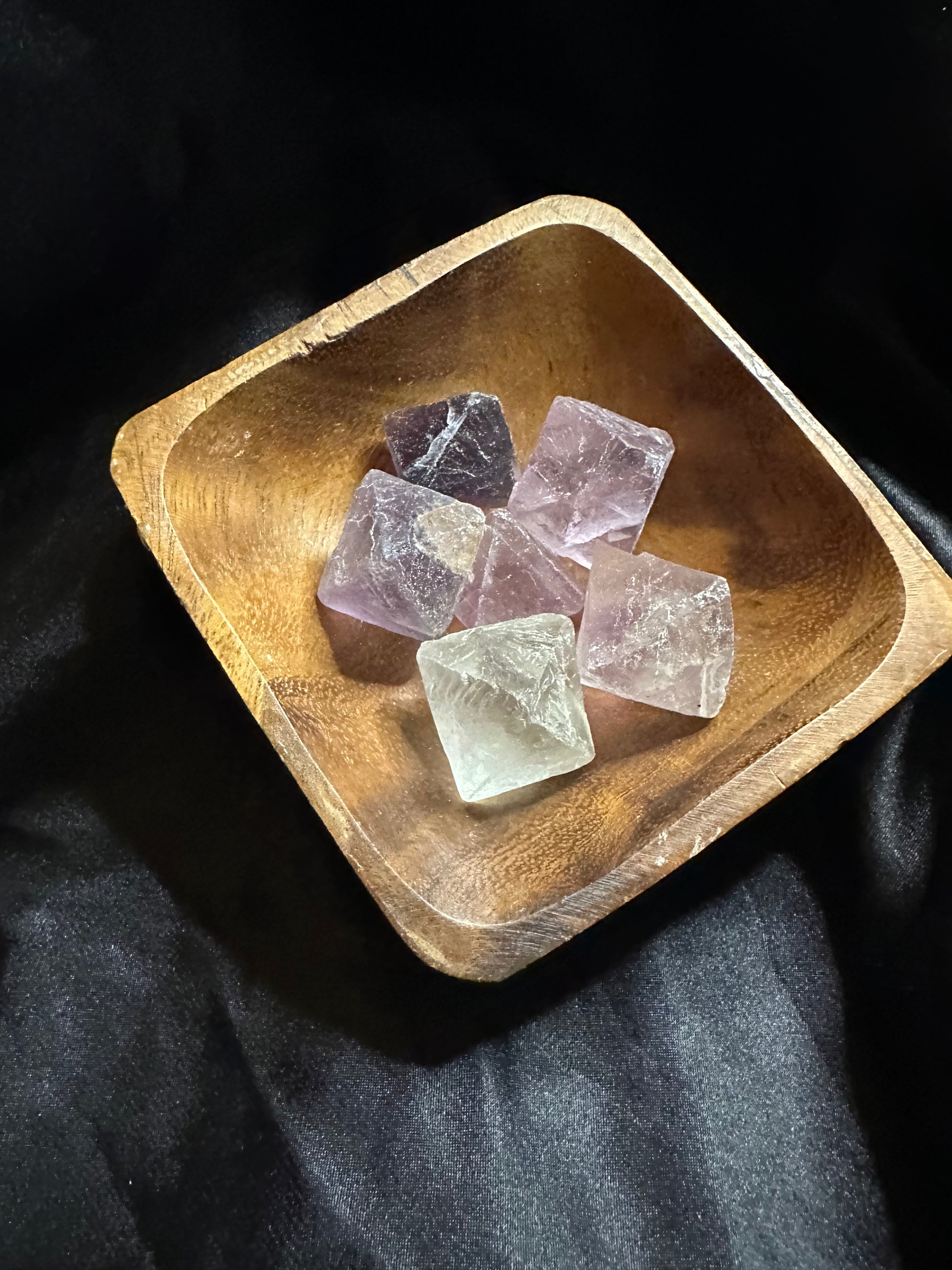 Rainbow Fluorite Natural Polyhedron carved crystal, held in hand for scale