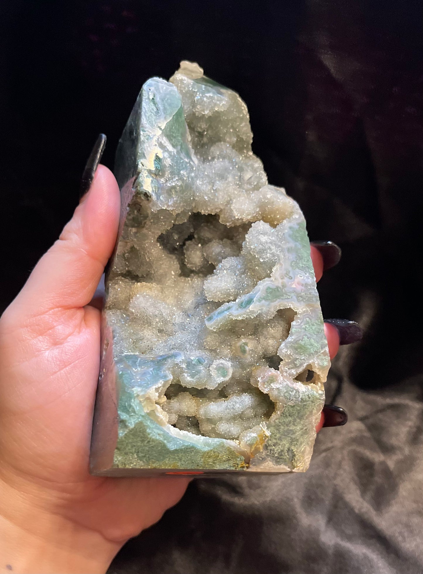 Moss Agate Druzy crystal tower, shown against a dark backdrop