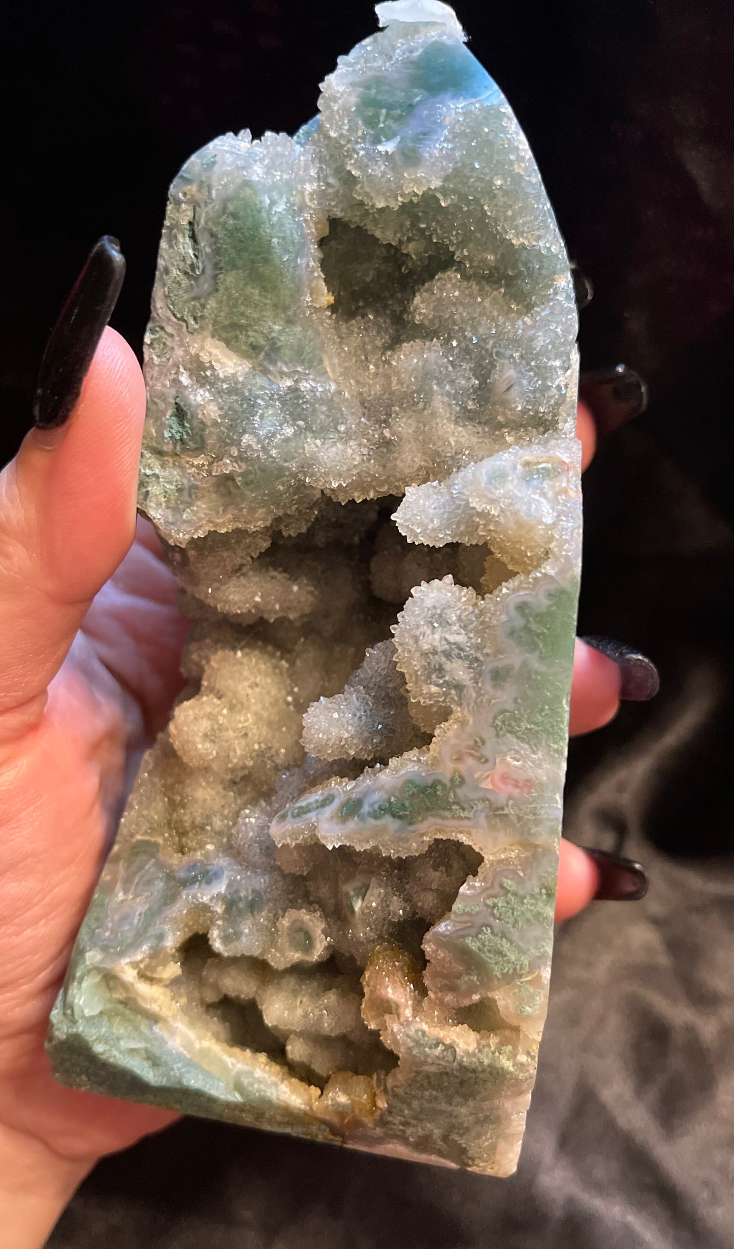 Moss Agate Druzy crystal tower, held in hand for scale